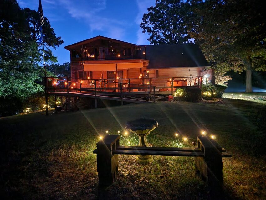 backyard lit up by solar lights at night